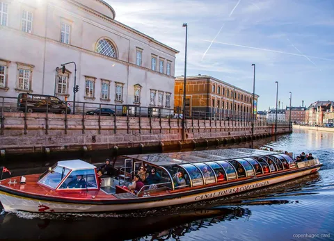 Copenhagen Canal Cruise passing Christiansborg Palace along the water