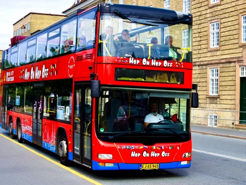 Miljøvenlig dobbeltdækkerbus fra hop-on hop-off-bussen i København ved et byens stop